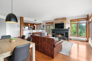 a living room with a couch and a fireplace at Tremblant Prestige - Altitude 172-8 in Mont-Tremblant +16 photos