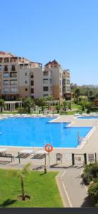 イスラ・カネラにあるApartamento Los Pelícanosの建物を背景にした大きなプールの眺め