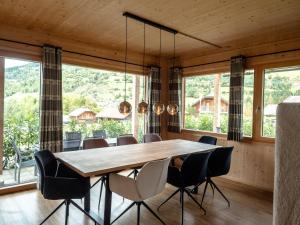 a dining room with a wooden table and chairs at Alpenchalét Alpakablick in Sankt Lorenzen ob Murau