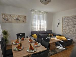 a living room with a table with plates of food on it at Sea Sand in Friedrichshafen