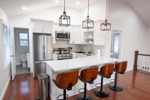 a kitchen with white cabinets and a white counter top at Modern Retreat Poconos 3BR Fire Pit Skiing in East Stroudsburg