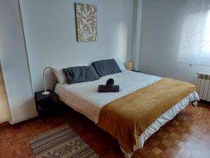 a bedroom with a bed with a stuffed animal on it at Vida Boa in El Dueso