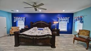 a bedroom with a bed and a blue wall at 100Ft To Beach,Beachview,EV charger,Heated Pool,Jacuzzi in South Padre Island