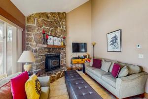 a living room with a couch and a fireplace at Mountain Dreams Condo in Fraser