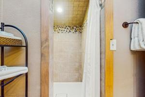 a bathroom with a shower with a shower curtain at Mountain Dreams Condo in Fraser +11 photos