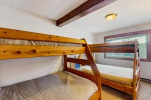 two bunk beds in a room with a window at Mountain Dreams Condo in Fraser