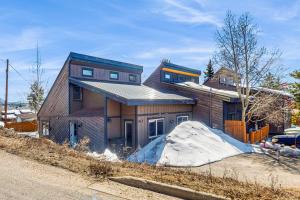 a house on the side of a road with snow at Mountain Dreams Condo in Fraser