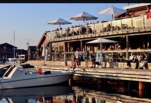 a boat is docked in front of a restaurant at Guest House Gäststuga Bullandö in the archipelago in Värmdö +5 photos