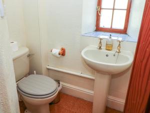 a bathroom with a toilet and a sink at Slade Cottage in Ashbourne +30 photos