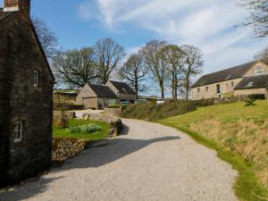 a winding road through a village with buildings at Slade Cottage in Ashbourne