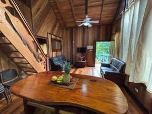 a dining room with a table with a pineapple on it at Casa Numú in Cahuita
