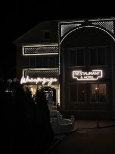 a restaurant with a sign in front of a building at Шахерезада in Vinnytsya +25 photos