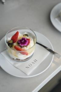 a bowl of fruit on a plate on a table at âmé by NOAH in Cape Town
