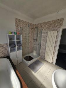 a bathroom with a shower and a tub and a sink at Spacious Bournemouth Home with BBQ, Outdoor Seating & large TV in Bournemouth