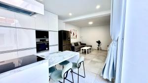 a kitchen and living room with a table and chairs at The white house in Vecindario