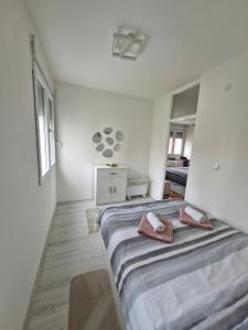 a bedroom with a bed with two towels on it at ZONA apartman in Vranje