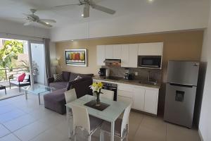 a kitchen and living room with a table and a couch at Departamento Hanna #3 Bucerias in Bucerías