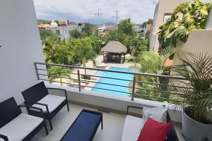 a balcony with a view of a swimming pool at Departamento Hanna #3 Bucerias in Bucerías