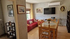 a living room with a table and a red couch at Villa Dona Bella in Donji Bitelić