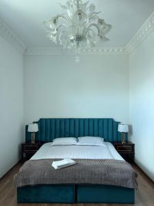 a bedroom with a large bed with a green headboard at Otyak Hotel EVN Zvartnots Airport in Pʼarakʼar +42 photos