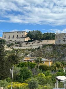 a building on the side of a hill with houses at Terra del Gattopardo in Palma di Montechiaro +19 photos