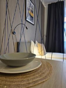 a plate on a table with a bowl on it at Bird Home Room 8 in Klagenfurt