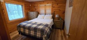 a small bedroom with a bed and a window at Wandering Woods- 3 Bedroom Home with Hot Tub and Firepit in Oakland