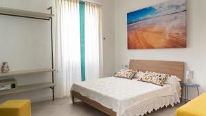 a bedroom with a bed and a large window at Domo Andi in La Maddalena +26 photos