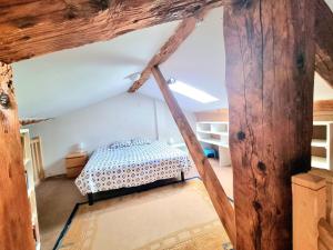 a bedroom with a bed in a attic at Le Clos des Jardiniers 1 in Villefranche-sur-Saône