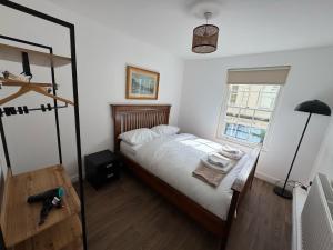 a bedroom with a bed and a window at Rustic Elegance Town Centre Flat in Ipswich