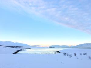 a view of a frozen lake in the snow at Vacation Home Fagravik in Akureyri