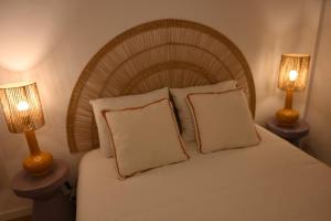 a bedroom with a bed with two lamps on tables at Downtown Cosy in Vila Real