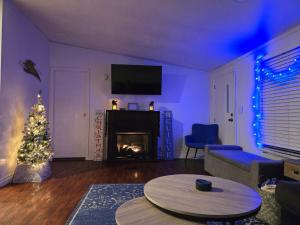 a living room with a christmas tree and a fireplace at Cute Shawnee Twin Lakes home sleeps 10&has it all! in Shawnee