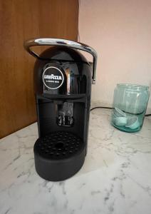 a coffee maker sitting on a counter next to a glass at Villetta La Risacca - fronte mare - seafront in Costa Paradiso