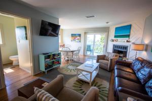 a living room with a couch and a table at Sea Cliffs #10 in Blue Mountain Beach