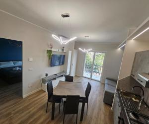une salle à manger et un salon avec une table et des chaises dans l'établissement Blu Sky Apartment, à Santa Maria delle Mole