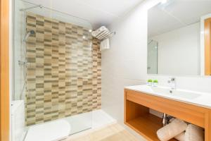 a bathroom with a sink and a shower at Apartaments Condado by Marsol in Lloret de Mar