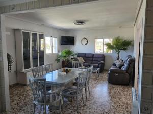 a living room with a table and chairs and a couch at Vive la playa a lo grande!!! in Cullera