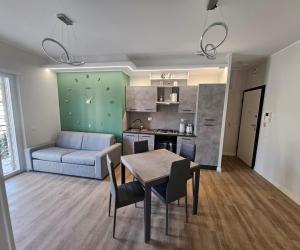 a kitchen and living room with a table and a couch at Green Suite Apartment in Santa Maria delle Mole +19 photos
