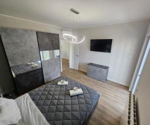 a bedroom with a bed with two towels on it at Green Suite Apartment in Santa Maria delle Mole