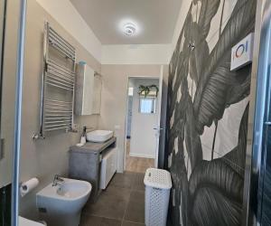 a bathroom with a sink and a toilet at Green Suite Apartment in Santa Maria delle Mole