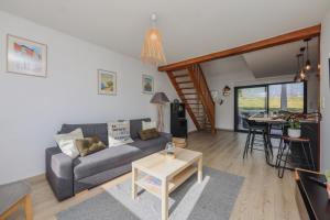 a living room with a couch and a table at La Marine, maison en plein cœur de Wimereux in Wimereux