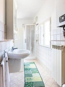 a white bathroom with a sink and a toilet at Domus Albano laziale in Albano Laziale