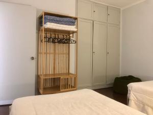a room with a bed and a shelf with towels at Olivia's Place in Funchal