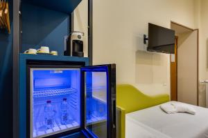 a room with a refrigerator with water bottles in it at Seven in Rome