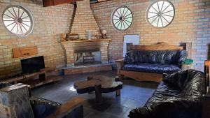 a living room with a couch and a fireplace at Casa de Campo em Biritiba Mirim in Biritiba-Mirim