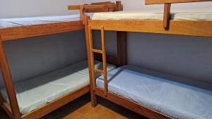 a bedroom with two bunk beds with a blue mattress at Casa de Campo em Biritiba Mirim in Biritiba-Mirim