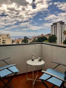 a table and chairs on top of a balcony at Olivia's Place in Funchal