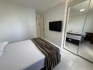 a hotel room with a bed and a television at Edificio Neo Apto 401 in Maceió +17 photos