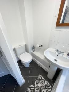 a bathroom with a toilet and a sink at Cute two bedroom house with free street parking in Liverpool